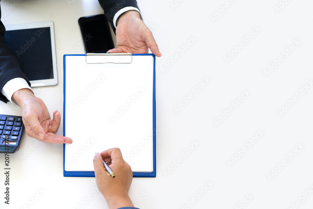 Businessman offers a empty document on clipboard and pointing at the line needs signature with copy space.empty document for graphic display montage. Businessman offers a empty document on clipboard and pointing at the line needs signature with copy space.empty document for graphic display montage.
