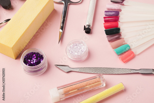 Manicure supplies on pink background photo