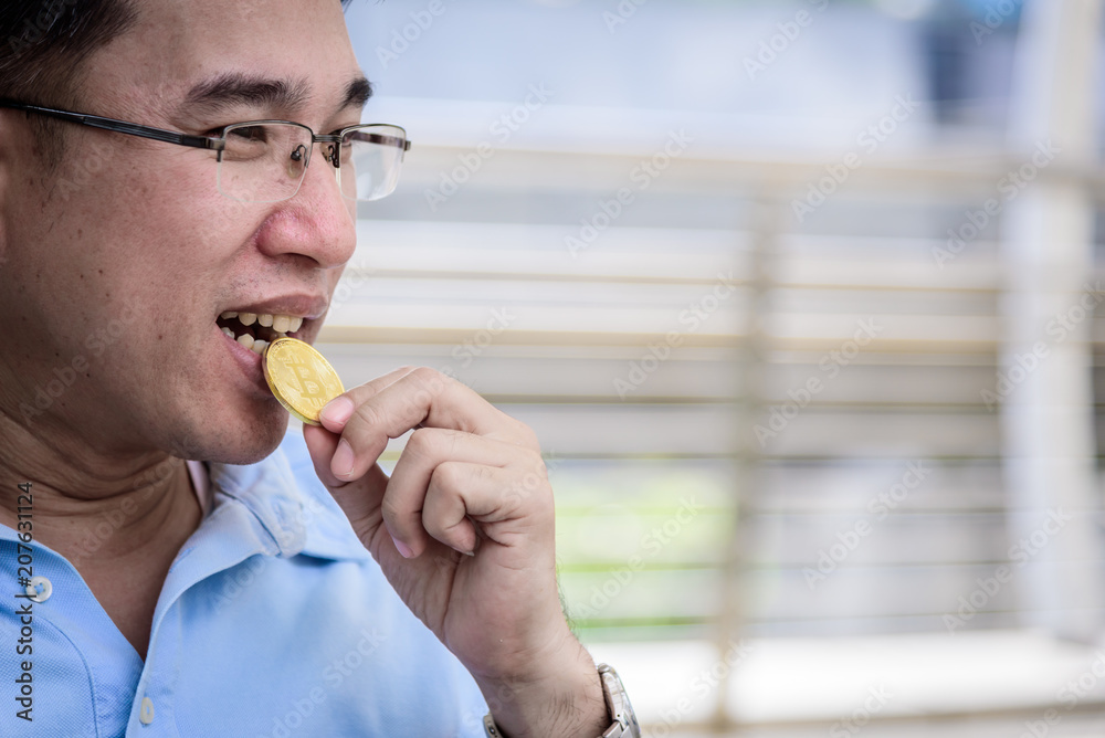Adisn business man has kissing on bit coin money with happy. Adisn business man has kissing on bit coin money with happy.