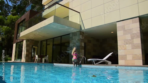 Woman sunbathing at Villa wiht private pool
