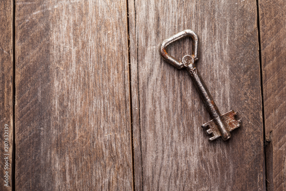 old keys on a brown wooden background old keys on a brown wooden background