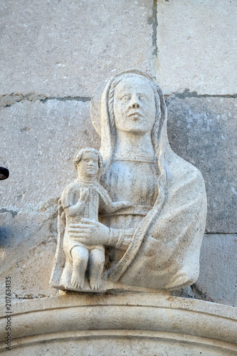 Statue of Virgin Mary with baby Jesus on the St Mark's Cathedral in the historic city Korcula at the island Korcula in Croatia 