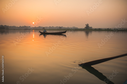 Little boat on the water at sunrise
