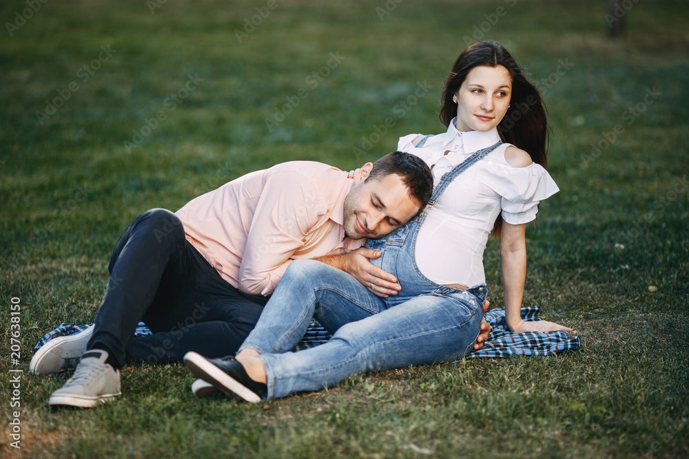 Happy man hugging pregnant wife's belly Happy man hugging pregnant wife's belly