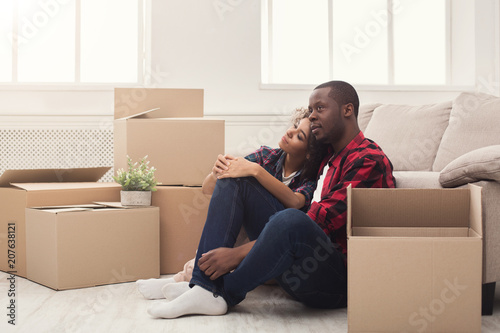 Young balck couple unpacking moving boxes