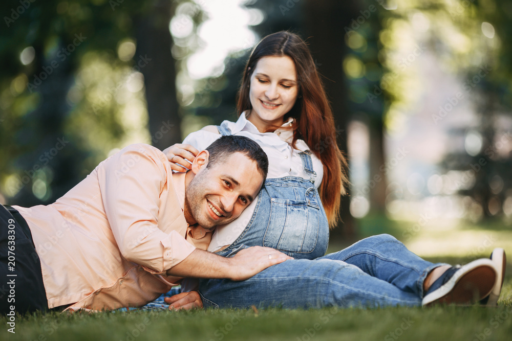 Father hearing his son kicking inside mother belly