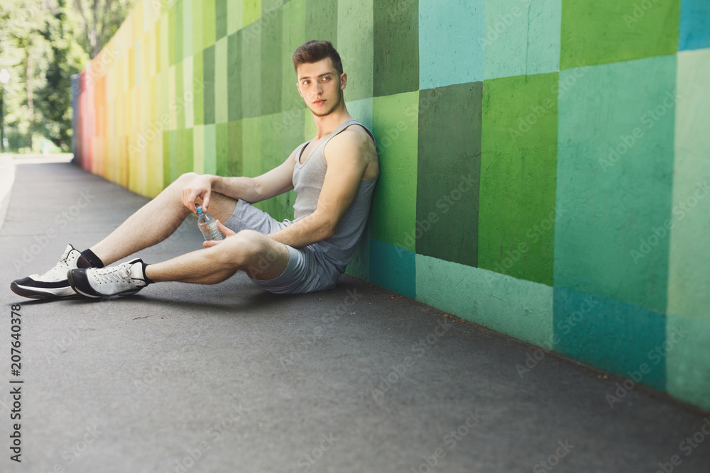 Tired man runner is having break after training Tired man runner is having break after training