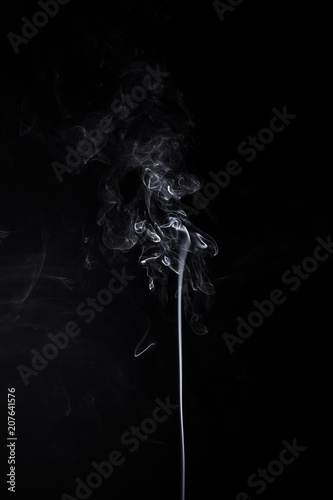 Vertical swirl of burning aromastick photo