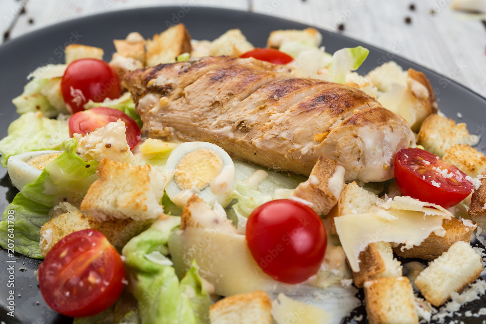 Healthy Grilled Chicken Caesar Salad with Cheese, Croutons and Cherry Tomatoes