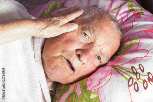 Elderly 80 plus year old man in a home bed. photo