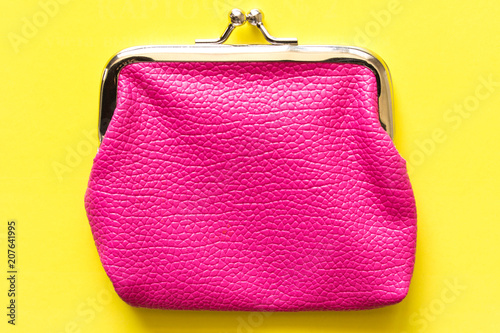 Pink wallet on a yellow background . Close up. Top view