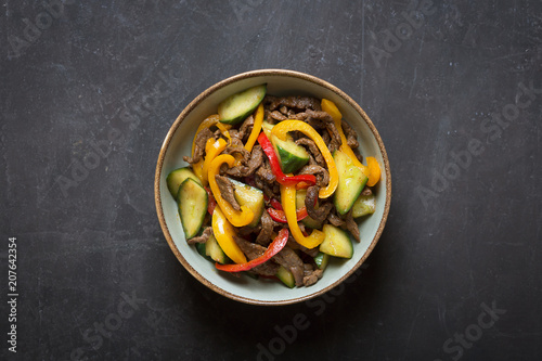Traditional asian salad prepared with meat,onions and bell pepper. Top view