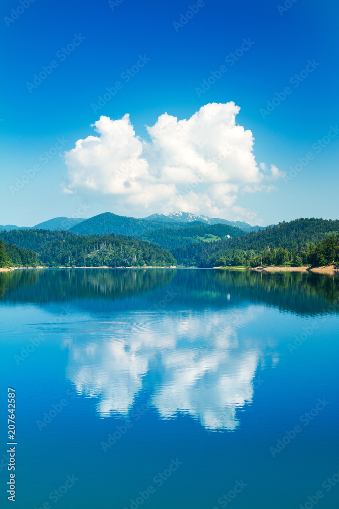 Panoramic view of beautiful Lokvarsko lake with Risnjak mountain in background, beautiful colorful mountain landscape, reflection, Lokve, Gorski kotar, Croatia Panoramic view of beautiful Lokvarsko lake with Risnjak mountain in background, beautiful colorful mountain landscape, reflection, Lokve, Gorski kotar, Croatia