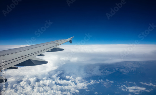 Plane wing on blue sky background
