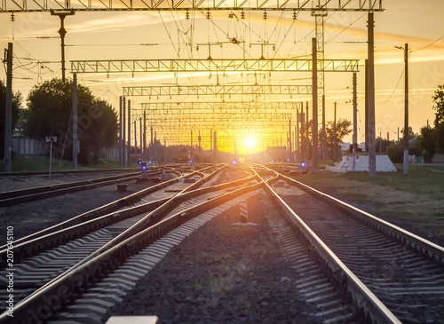 Branching of railways against the background of a bright sunset