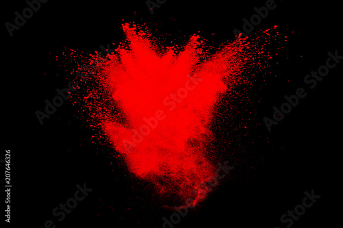 abstract red powder explosion on black background. Freeze motion of red powder splash.