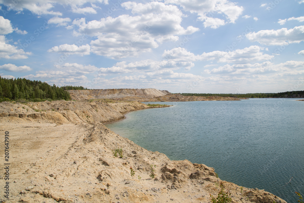 Flooded open pit quarry ore clay mining with blue water