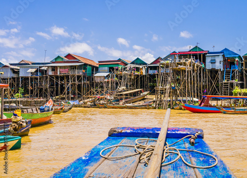 Picturesque Kampong Phluk floating village with multicolored boats and stilt houses, Tonle Sap lake, Siem Reap Province, Cambodia
 photo