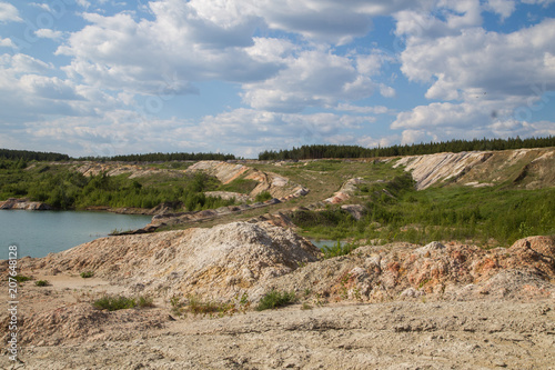 Flooded open pit quarry lake ore clay mining with blue water