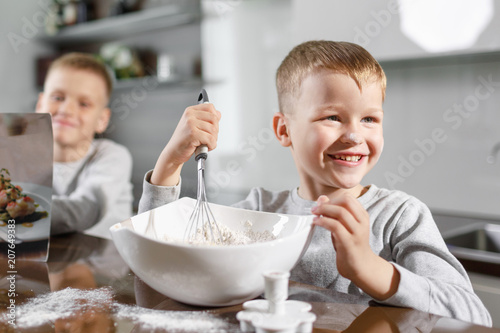 two little brothers help mom prepare delicious and healthy breakfast