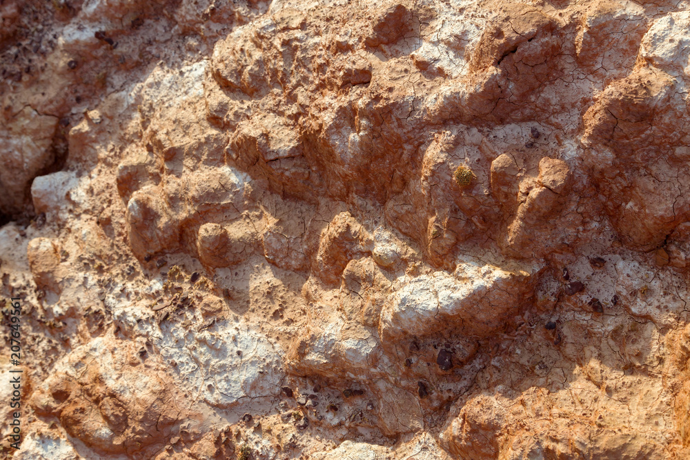 Uneven Red dry soil with fragments of saline soil