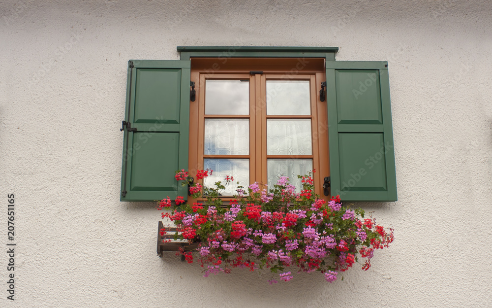 old house window with beautiful flowers