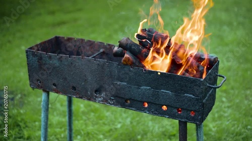 Slow motion of coal burns in brazier.