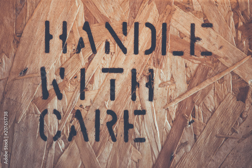 Fine image close-up of fragile symbol on wood board.material label beside the transportation wooden box  standard package in the truck