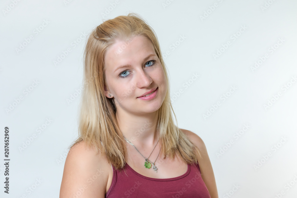Studio shot of the slightly smiling attractive young blond woman posing in sportswear Studio shot of the slightly smiling attractive young blond woman posing in sportswear
