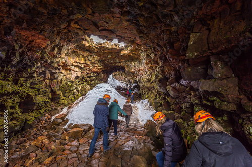 Raufarholshellir - May 04, 2018: Travelers entering the Raufarholshellir lava tunnels, Iceland photo