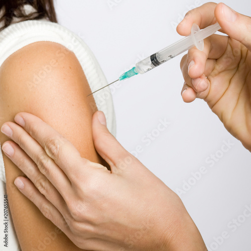 Nurse putting an injection in the arm