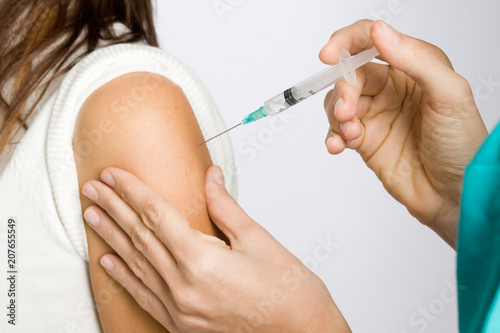 Nurse putting an injection in the arm