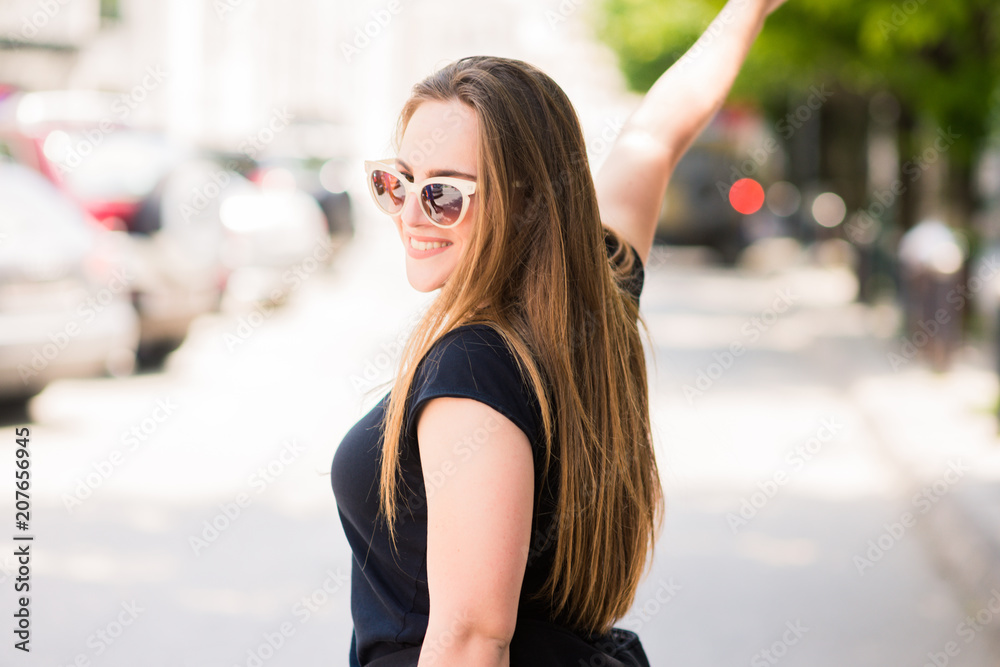 Cute Girl with sunglasses posing in the city