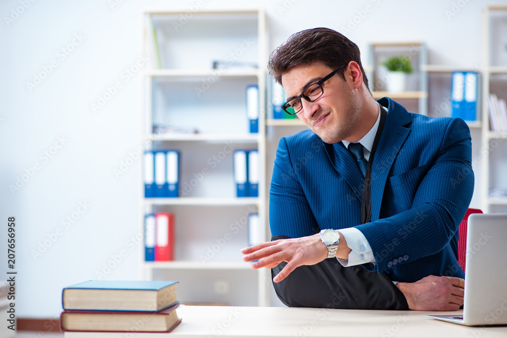 Businessman with broken arm working in office Businessman with broken arm working in office