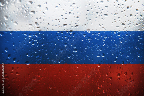 Foto Texture of the Russian flag on the glass with drops of rain.