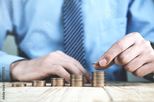  Businessman stacking coins. Concept of finance, investment and new idea.