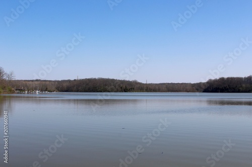 The calm water of the lake on a bright clear day.