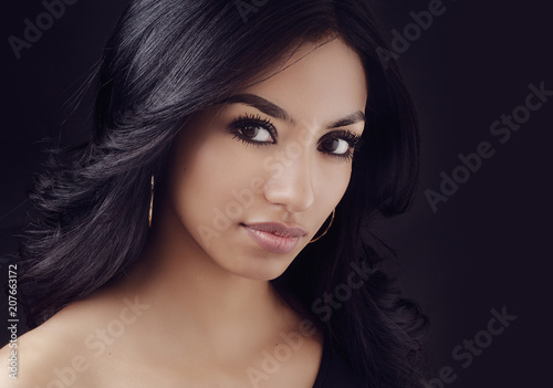 Attractive woman with long dark hair.