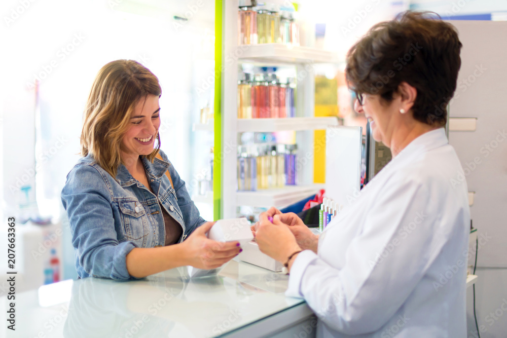 Pharmaceutical girl selling products to a customer Pharmaceutical girl selling products to a customer