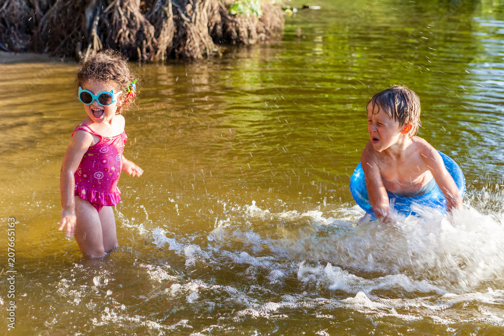 Children splash water on the beach Children splash water on the beach