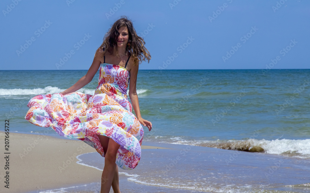 Young woman dancing in water of sea as symbol of freedom and happiness.