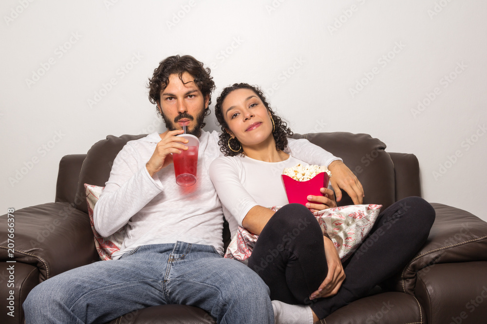 Sweet couple is at home watching movie. Romantic. Together and happy.. Sweet couple is at home watching movie. Romantic. Together and happy..