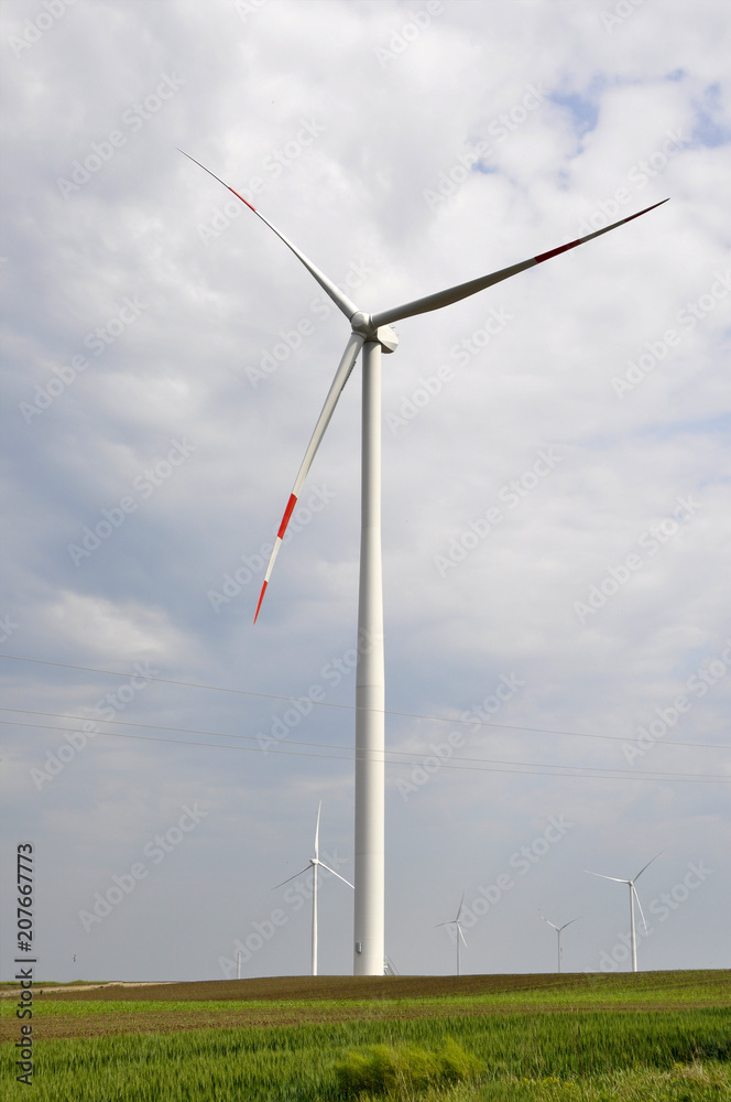 Wind turbine in the field producing energy. Wind turbine in the field producing energy.