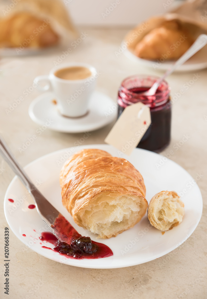 Fresh breakfast at morning. Croissant with jam and coffee.