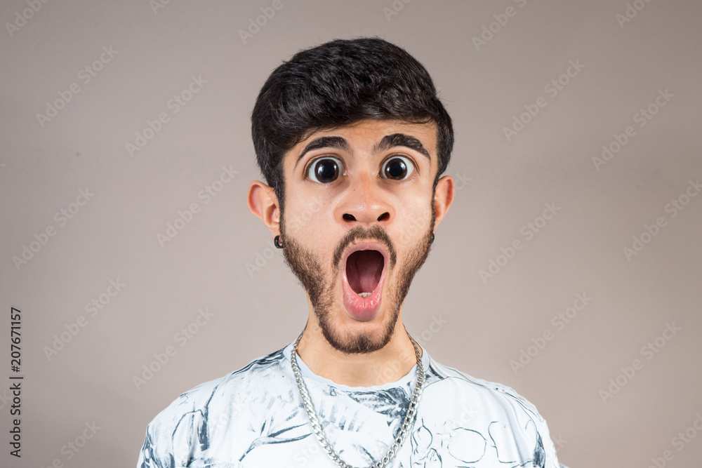 expression of amazement of young man with beard expression of amazement of young man with beard