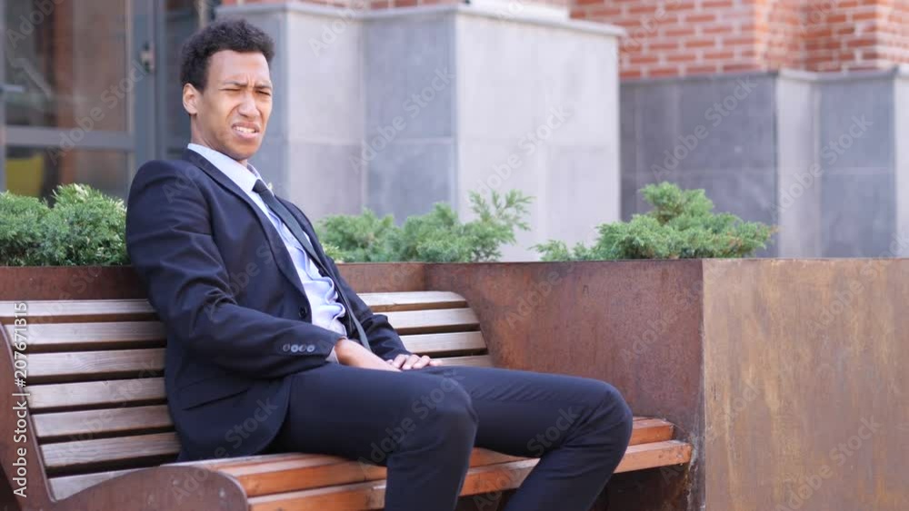 Thumbs Down by African Businessman at Work Looking at Camera Thumbs Down by African Businessman at Work Looking at Camera
