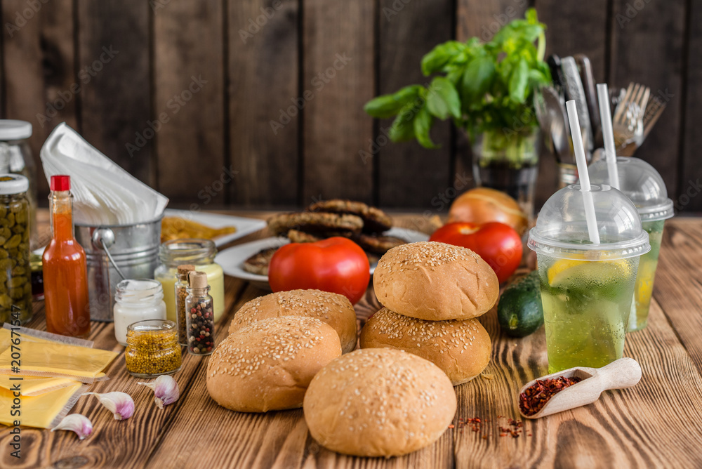 Tasty hamburger with meat and vegetables against a dark background. Fast food. It can be used as a background