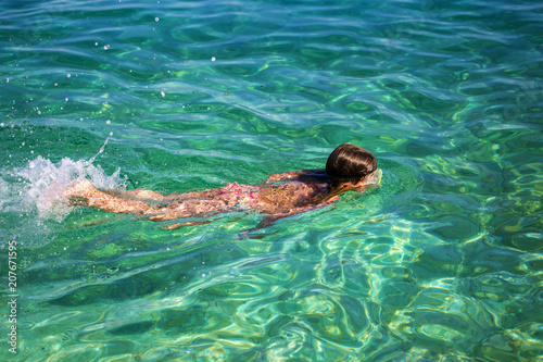Girl enjoying diving in beautiful Croatian sea. 