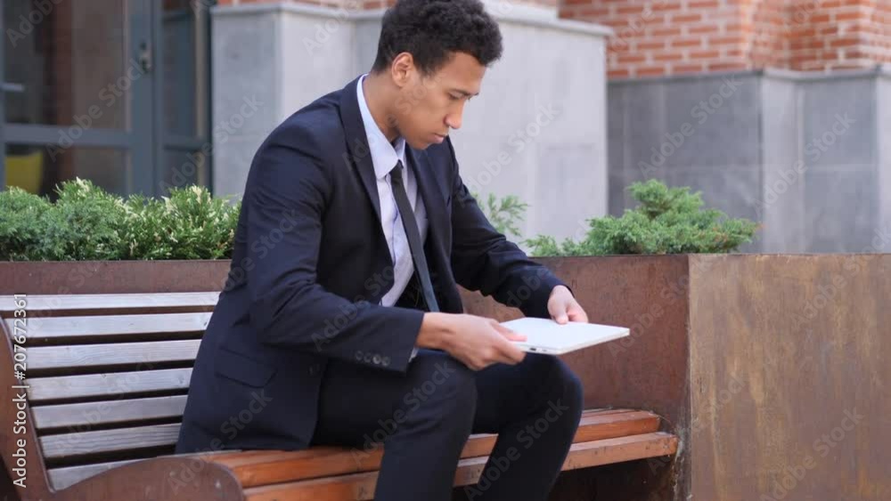 Designer Coming and Sitting on Bench and working on Laptop Designer Coming and Sitting on Bench and working on Laptop