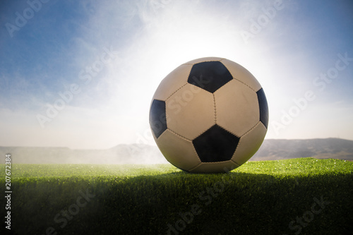 soccer ball on soccer field. Football on green grass. Sunny background